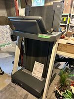Front view of folded Reebok R 6.90 treadmill with console and manual on deck