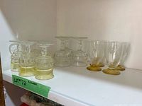 Shelf view showing group of clear and amber stemmed goblets