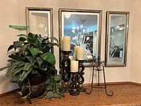 Overall lot showing three mirrors, plant, three candle holders with candles, and easel