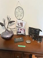 Group shot of all silver-plated items on cabinet