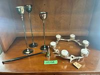 Group view of three tall candle holders, antler wreath holder with tealights, and snuffer