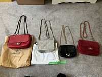 Front view of all four crossbody bags laid side by side