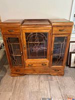 Front view closed showing glass doors and drawers