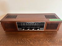 Front top view of Strauss LT-180 radio showing wood cabinet, speaker grills and control panel