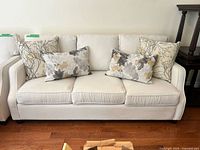 Front view of sofa with four decorative pillows displayed