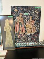 Both wall pieces side by side: tapestry on wall, framed metal art leaning