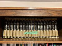 Front view of all 18 volumes on shelf
