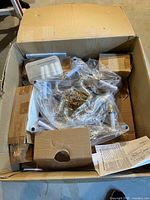Chandelier parts, sleeves, hardware and instructions inside original carton