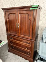 Front view showing double doors and three drawers