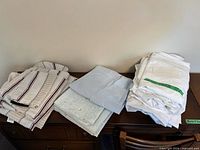 All three stacks of sheet sets on furniture