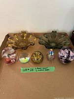 Group shot showing two flower-form bowls and five paperweights
