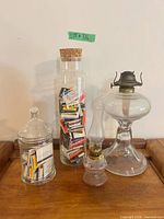 Group shot of both oil lamps and two matchbook jars