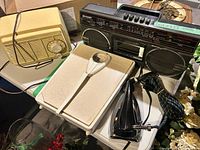 Group shot showing boombox, tabletop radio, iron, bathroom scale