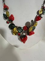 Front view of strawberry charm necklace on bust