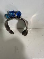 Top view of handmade silverware cuff showing bead cluster