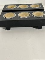 two black rectangular tealight holders with candles