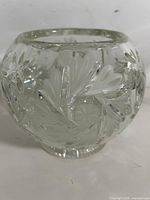 Front view of round cut crystal vase showing floral and starburst patterns