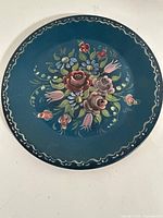 Front view showing floral Rosemaling design and border