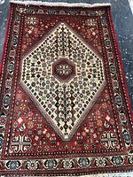 Full view of Persian carpet showing design and size