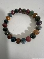 Full view of elastic bracelet showing multicoloured agate beads