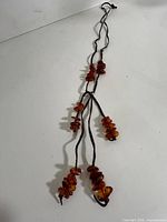 Full view of necklace showing multi strands and amber clusters
