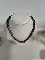 Front view of entire beaded necklace on display bust