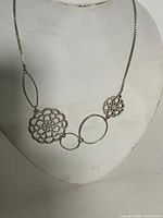 Front view showing full necklace layout and pendant arrangement