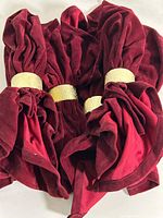 Group of six red velvet napkin rings showing gold metallic bands
