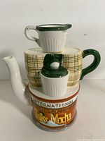 Front view of stacked ceramic teapot set