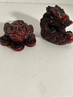Front view of money toad and dragon figurines