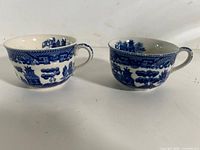 Front view of both Blue Willow teacups showing exterior pattern and handles