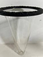 Overall view of glass vase showing conical shape and black rim