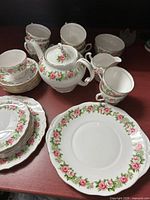 Front view of tea set showing teapot, cups, saucers, plates