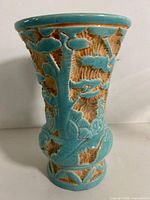 Front view of turquoise sgraffito vase