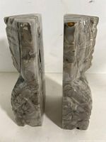Front view showing carving details and banded stone pattern