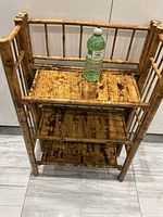 Front view showing three shelves and bamboo frame