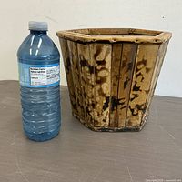 Front view of bamboo planter beside water bottle for scale
