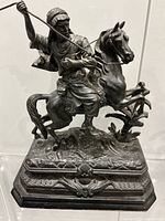 Front view of intact cast metal mounted warrior sculpture on base