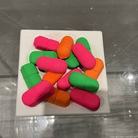 Oblique view showing colorful capsule forms on white base