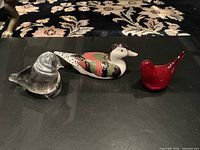 Front view of three bird figurines