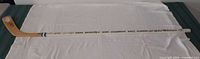 full view of hockey stick showing length and event text