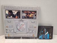 Front view of Babylon By Bus LP beside Classic 2-CD set