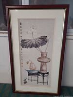 Full view of framed lotus still life artwork showing frame, mats, and subject