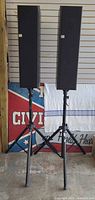 Both JBL Balboa 30 speakers on tripod stands with grills attached