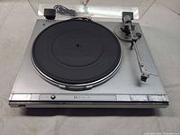 Top view of JVC L-A31 turntable with platter, tonearm and cords visible
