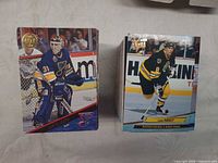 Two stacks of cards; top cards Curtis Joseph (Blues) and Cam Neely (Bruins) showing card design and condition