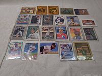 Front view of roughly 25 sleeved baseball trading cards laid out in five-by-five grid