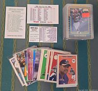 Stacked rookie cards, loose sleeved cards, three vintage pocket schedules visible