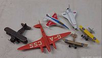 Top view of all six toy airplanes showing colors and types
