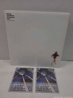 Front view of gatefold sleeve with two flyers laid below
